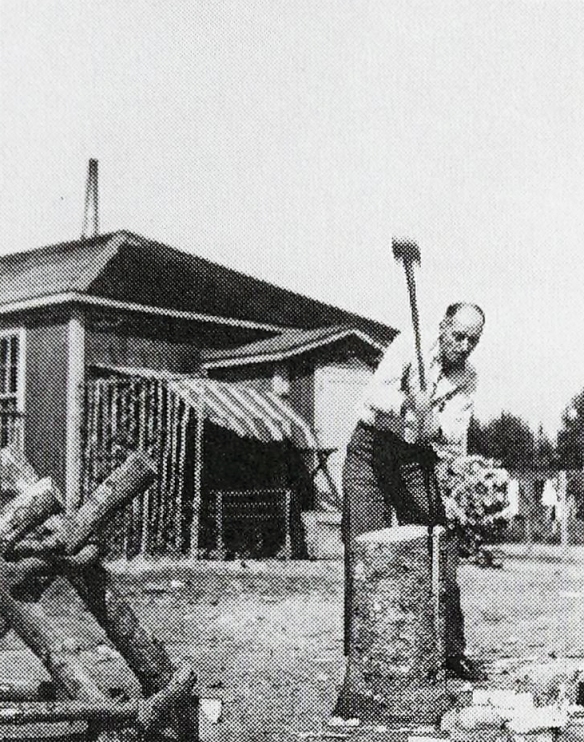 Arcand splits a log in Fredericton concentration camp at New Brunswick.
